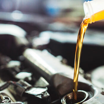 car-servicing-specialist--pouring-oil-into-an-engine
